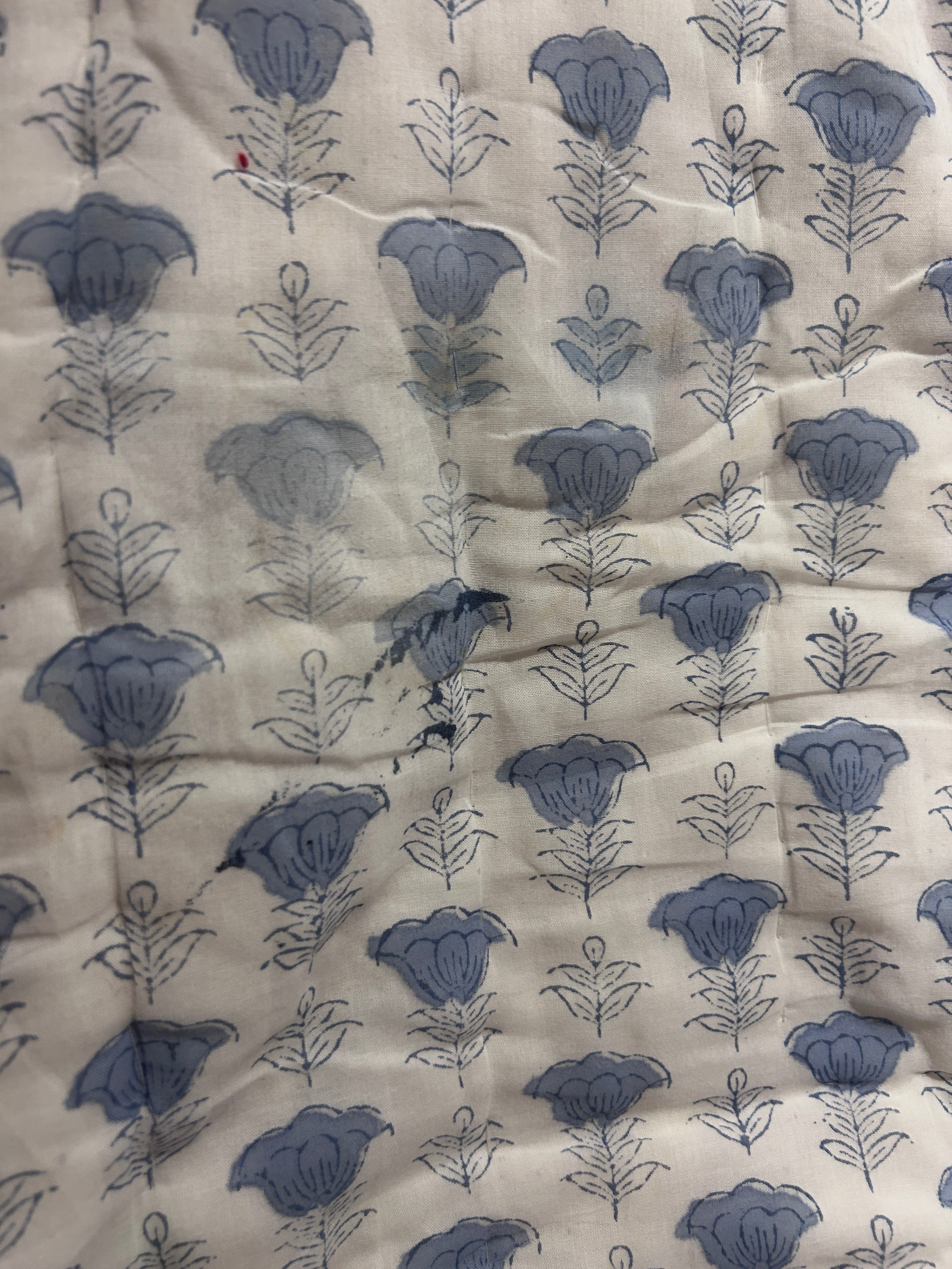 Floral patterned fabric with blue flowers on a beige background The Charpoy