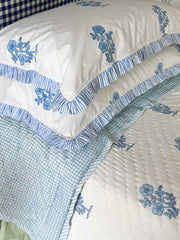 Jodhpur Blue Floral Hand Block Printed Quilt on a bed with matching pillows and checkered reverse, artisanal made in Jaipur by The Charpoy