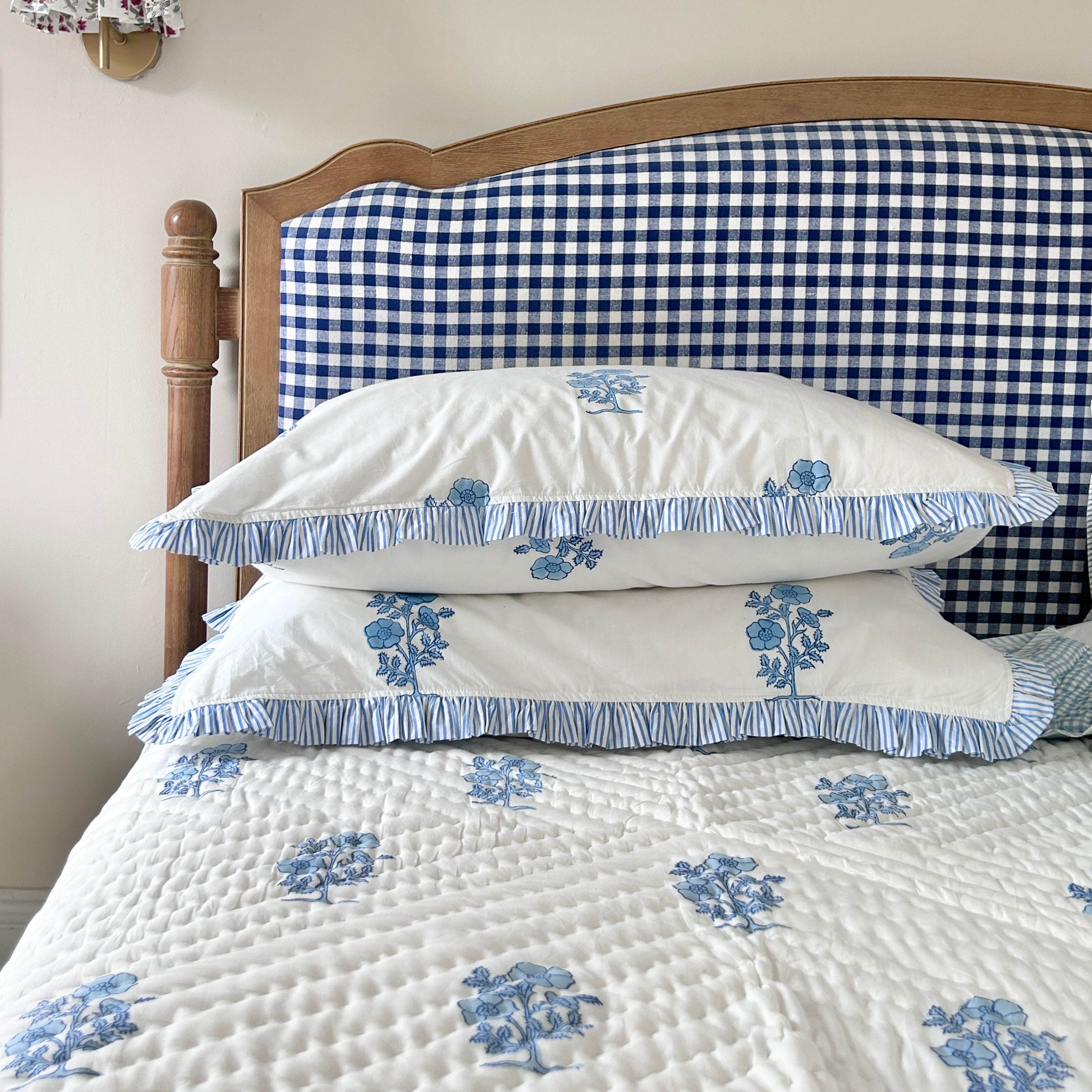 Jodhpur Blue Floral Hand Block Printed Quilt on a bed with matching pillows, artisanal made in Jaipur by The Charpoy