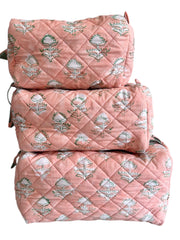 Set of three peach quilted wash bags with floral pattern on a white background The Charpoy