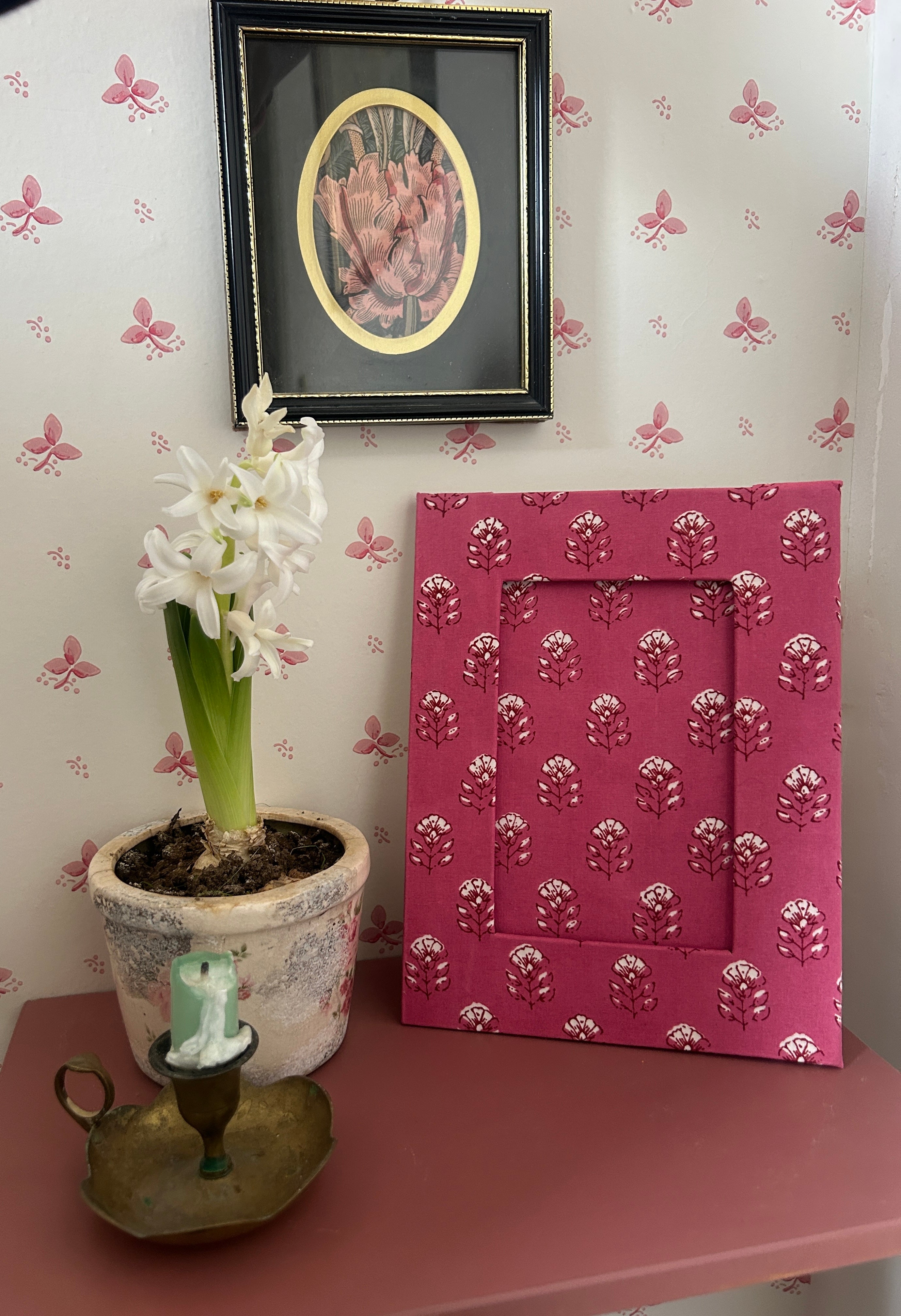Hand Block printed Pink photo frame with floral pattern on a table against a wall, handmade in Jaipur by The Charpoy