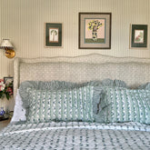 Petit Blue Flowers Scalloped Bedspread hand block printed shown on a bed with matching ruffled pillows by The Charpoy