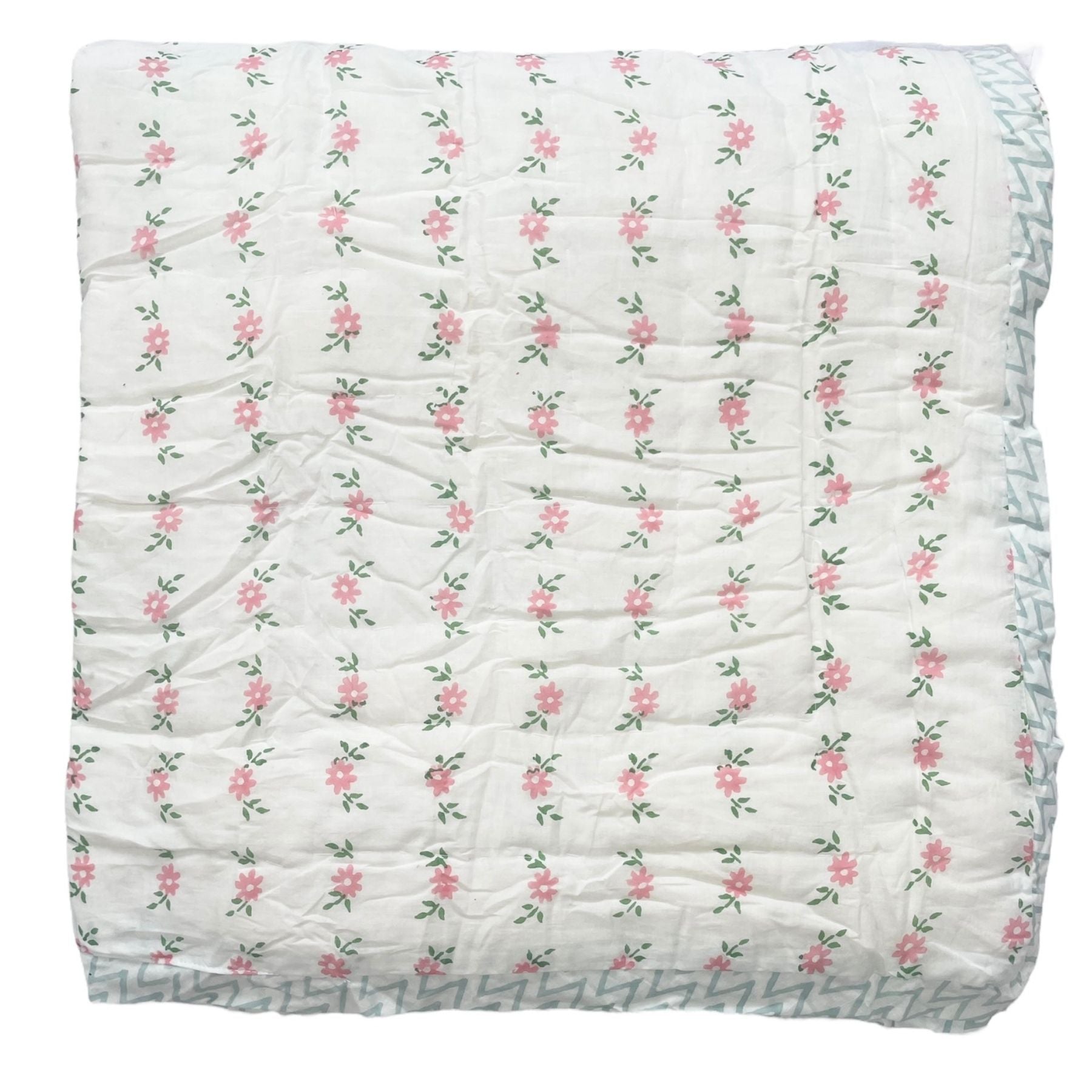 A hand block printed cotton quilt with a floral motif in pink and green, featuring a solid white background. The Charpoy