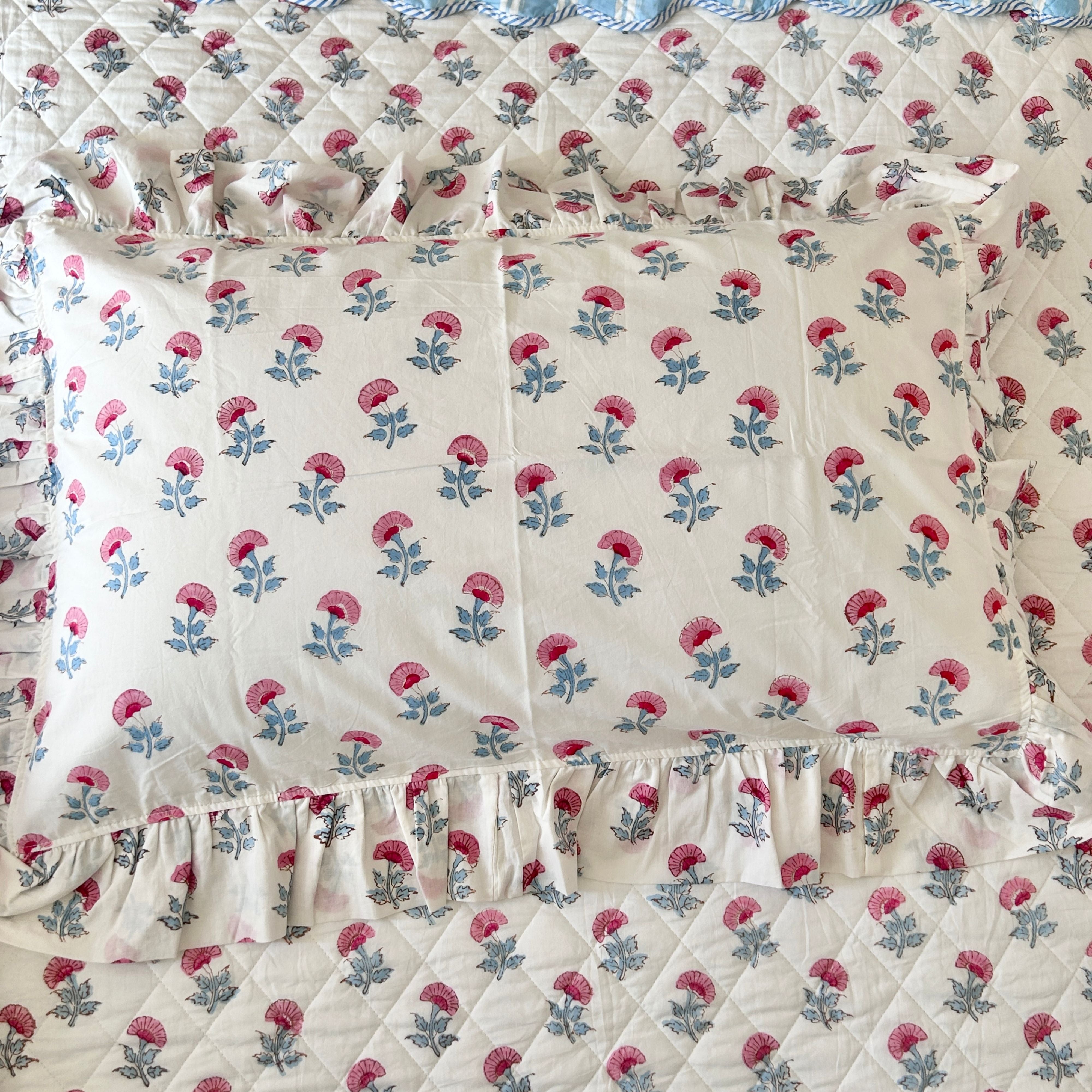 Floral patterned fabric with pink flowers pillow covers on a white background The Charpoy