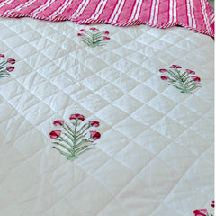 A close up of the super king bedpread dressed in pink and green flowers buta done with hand block printing, by The Charpoy