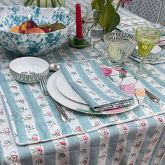 Aqua ruffled table cloth styled with place setting and matching napkins for The Charpoy