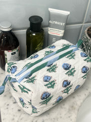 Floral-patterned toiletry bag with skincare products on a bathroom counter The Charpoy 