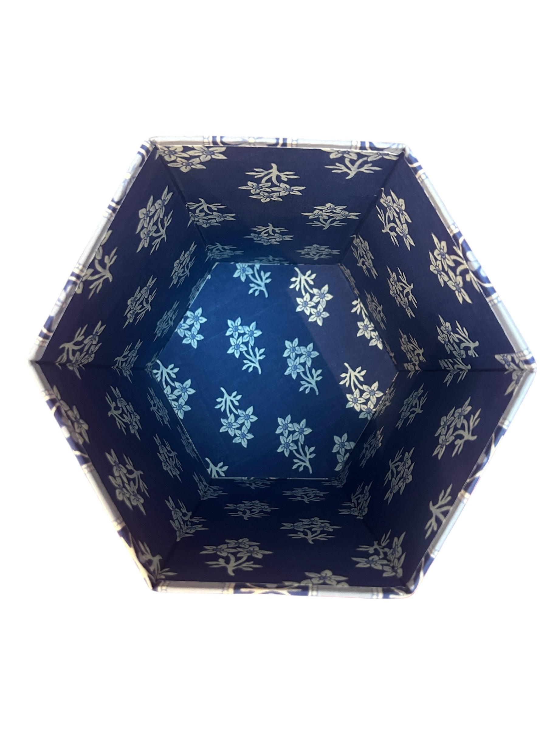 Hexagonal container with blue floral pattern on a white background