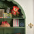 Hand Block Printed Photo frame with pink and green stripes The Charpoy on a green wall dresser  with other decorative items 