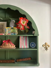 Hand Block Printed Photo frame with pink and green stripes The Charpoy on a green wall dresser  with other decorative items 