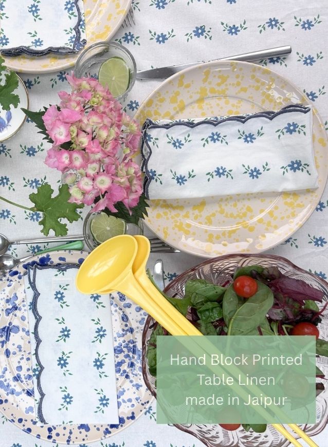 Hand block printed table linen with floral patterns and a yellow spoon on a matching tablecloth made by The Charpoy