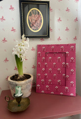 Hand Block printed Pink photo frame with floral pattern on a table against a wall, handmade in Jaipur by The Charpoy 