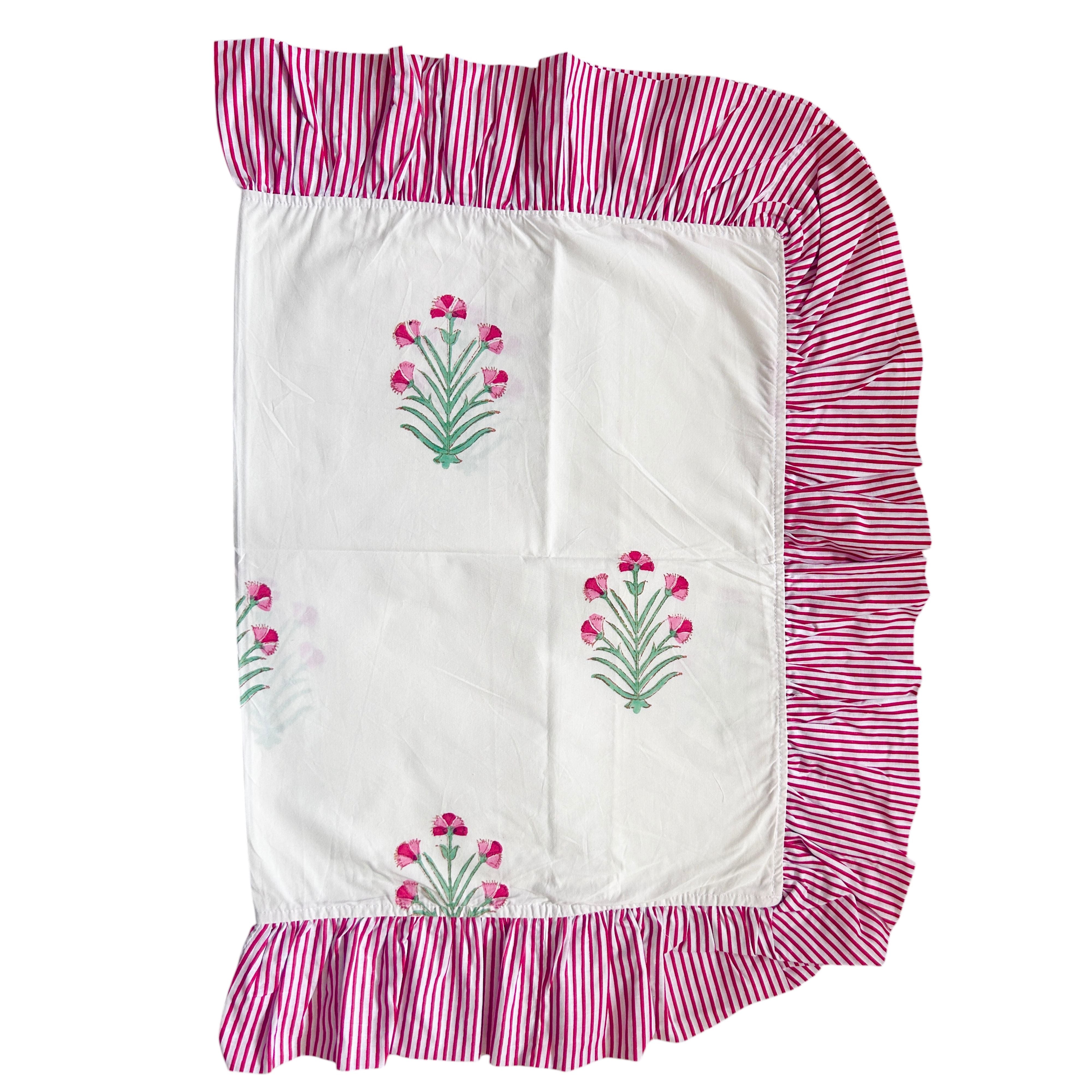 Hand block printed fabric with floral patterns and pink striped ruffled edges on a white background