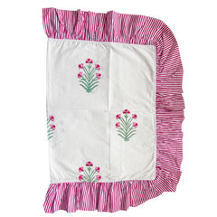 Hand block printed fabric with floral patterns and pink striped ruffled edges on a white background