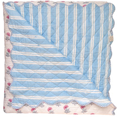 scalloped bedpread with blue and white striped pattern on reverse and floral pattern The Charpoy