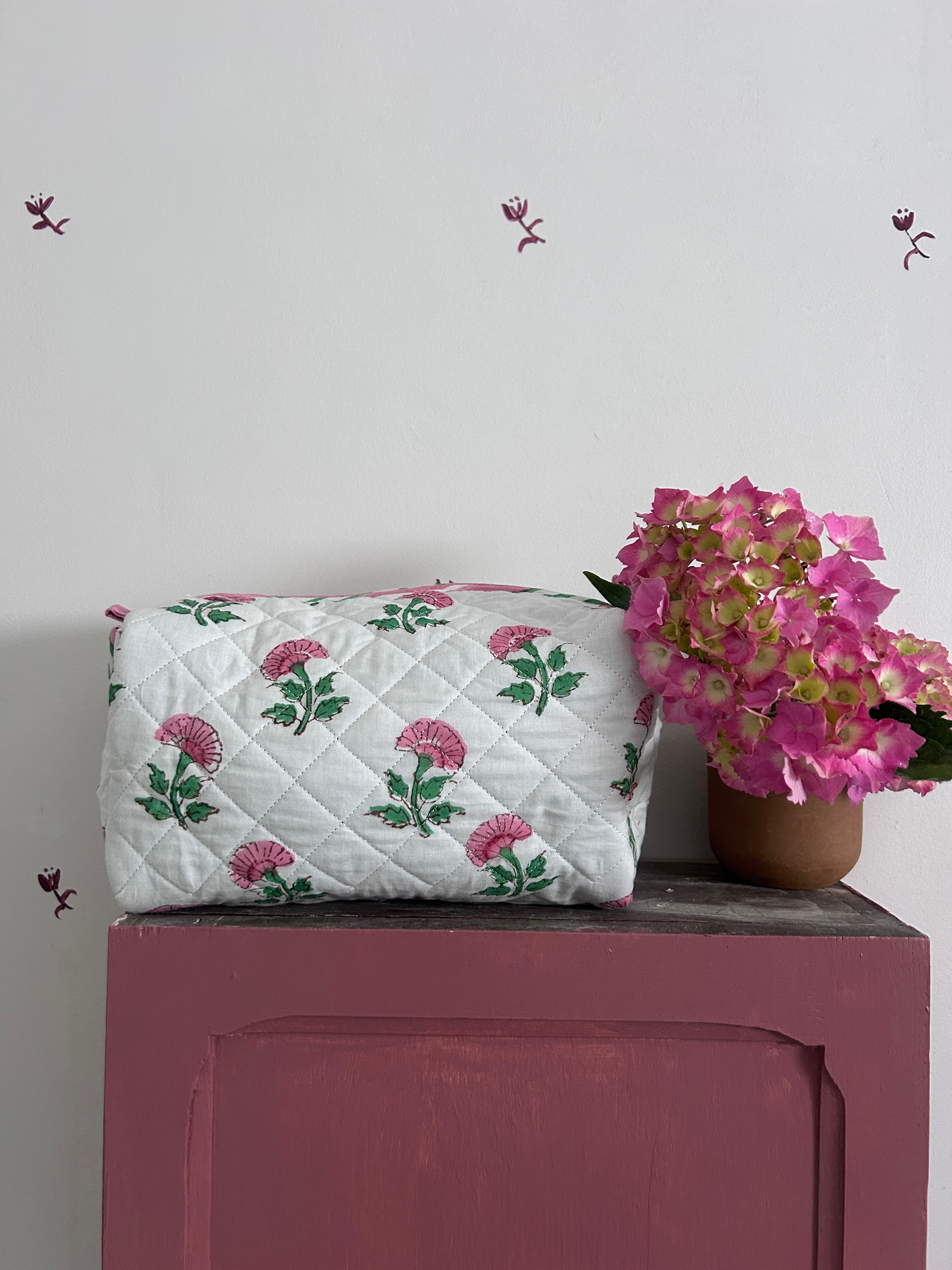 Pink And Green Flower Quilted Wash Bag hand block printed and lightly quilted by artisans in Jaipur by The Charpoy in a bathroom
