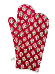 A pair of red oven gloves with a floral hand block print pattern.